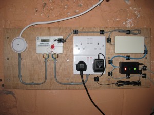 The server room meter with sensor, MK120 (white box), and junction box (black with LEDs).